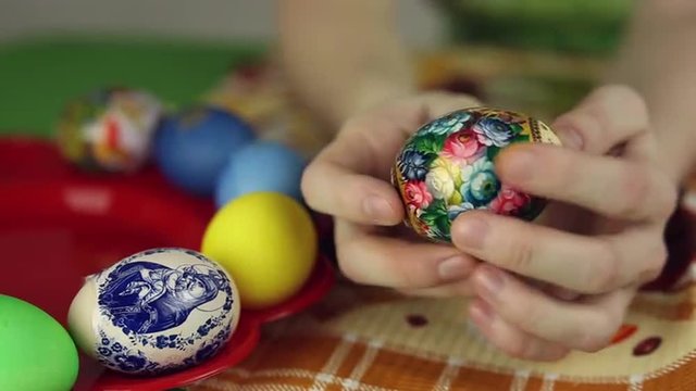 Preparation of Easter eggs, the feast of the passover, girl sticks decorative stickers on the Easter eggs
