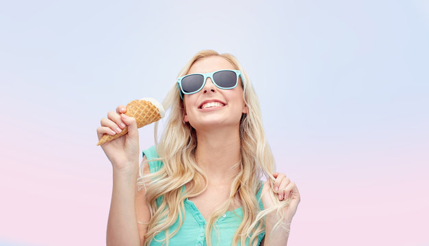 happy young woman in sunglasses eating ice cream