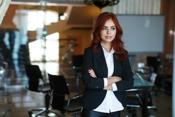 young beautiful business woman stands in the office