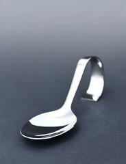 Close-up of a silver spoon with copy space. 