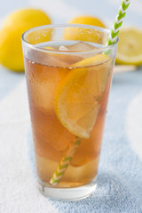 Ice tea with lemon on a beach towel

