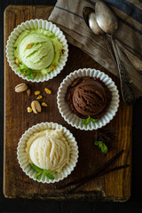 Selection of colorful ice cream scoops in white bowls