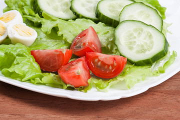 Fresh salad in a white bowl .