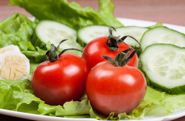 Fresh salad in a white bowl .
