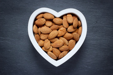 Heart shaped bowl filled with almonds