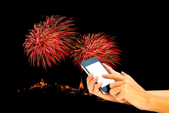 Hand use smart phone  with image of firework as a background