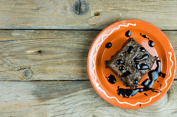 Black cake with chocolate on old  table
