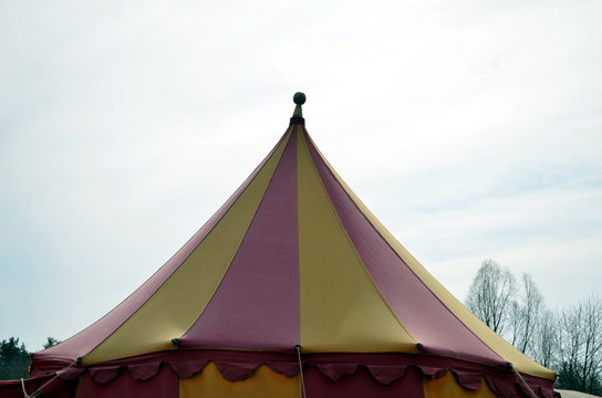 top of a medieval circus tent colorful with blue sky