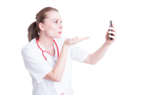 Woman doctor sending blowing kisses on video call