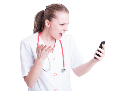 Angry mad doctor or medic woman yelling at phone