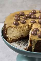 Cheesecake with malteesers and very sweet, dense mass formed during the cooking of milk or cream and sugar. 
Beige background.