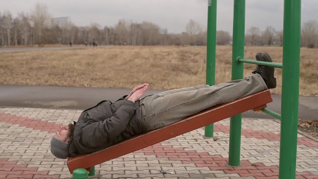 Man exercising abs outdoors