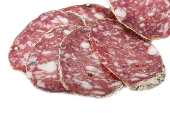 pork salami sliced on a white background