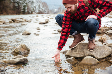 Male hiker testing water