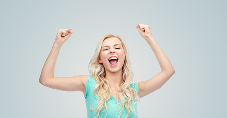 happy young woman or teen girl celebrating victory