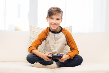 happy boy with joystick playing video game at home © Syda Productions