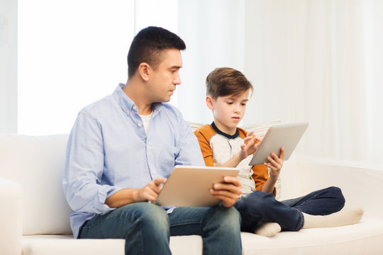 father and son with tablet pc at home