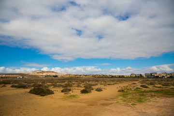 Fototapeta na wymiar The barren landscape of Fuerteventura on a warm, sunny day, with a decent amount of cloud cover.