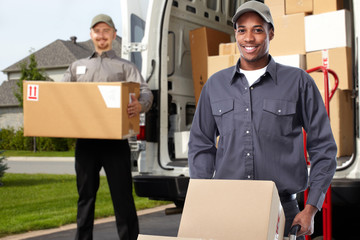 Delivery man near shipping truck.