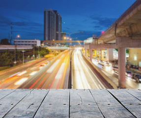 empty rustic wooden table and with blurring lights of cityscape background, for product display