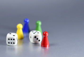 Playing pieces and dice, isolated grey background