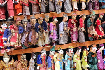 Colorful traditional puppets are sold as souvenirs on the street in Mandalay, Myanmar.