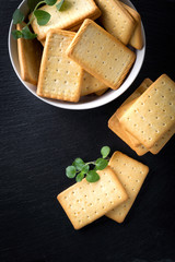 dry salted crackers on granite plate with oregano