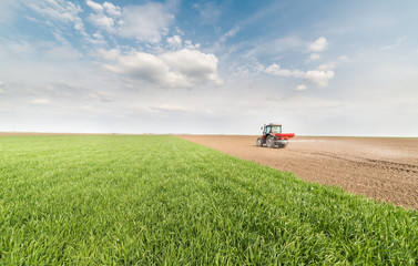  tractor fertilizing in field