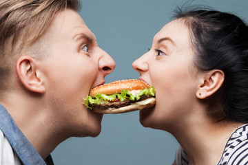 Man and woman eating a burger
