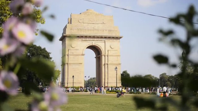 Locked-on shot of tourists at India Gate, New Delhi, India 