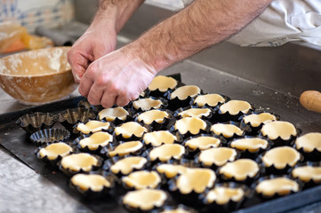 Baker Preparing Pastry for Small Tarts in Bakery