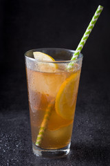 Ice tea with lemon. Black stone
