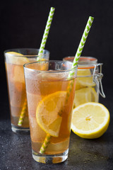 Ice tea with lemon. Black stone

