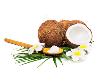 Coconuts with green leaves on white background