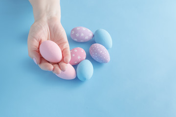 close up of woman hands holding colored easter eggs