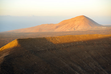 Fototapeta na wymiar Volcanic landscape view from the top of Caldera Blanca volcano on the sunset on Lanzarote island in Spain