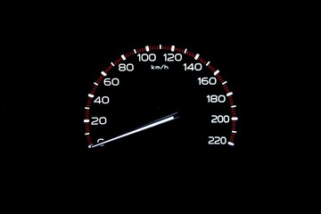 driver's cockpit ; speedometer on dashboard - white light in black, copy space for your design
