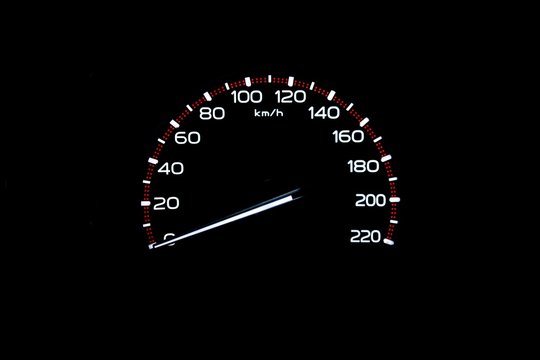 driver's cockpit ; speedometer on dashboard - white light in black, copy space for your design
