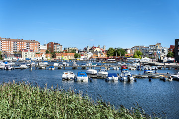 Fototapeta na wymiar Karlskrona, Sweden - July 07, 2014: Central marina with boats, pier and buildings