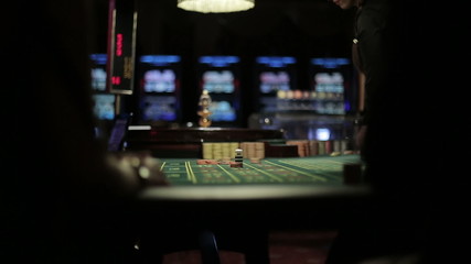 People placing bets for roulette in casino, winnings close up