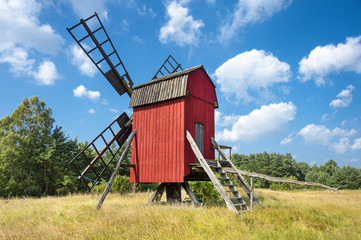 Red windmill, yellow field and blue sky on Baltic Sea island Oland, Sweden