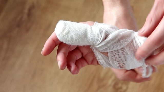 Unwinding the bandage from his hand, part 1
