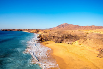 Fototapeta na wymiar Papagayo beach near Las Coloradas resort on the south of Lanzarote island in Spain