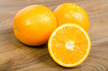 Slice of fresh orange on wood background