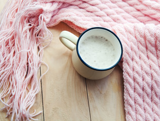 hot Cup of cappuccino and pink  woolen blanket. Cozy  house