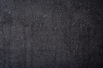 Black stone background with raindrops
