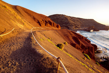 Footpath to El Golfo bay on the sunset on Lanzarote island in Spain