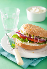 tomato sandwich on bagel with cream cheese onion lettuce alfalfa
