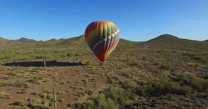 Hot air balloon in open desert fly away
