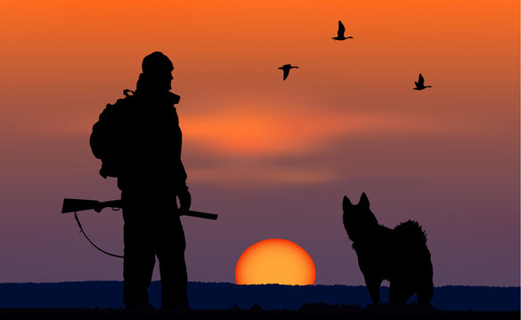 hunter with dog at sunset background